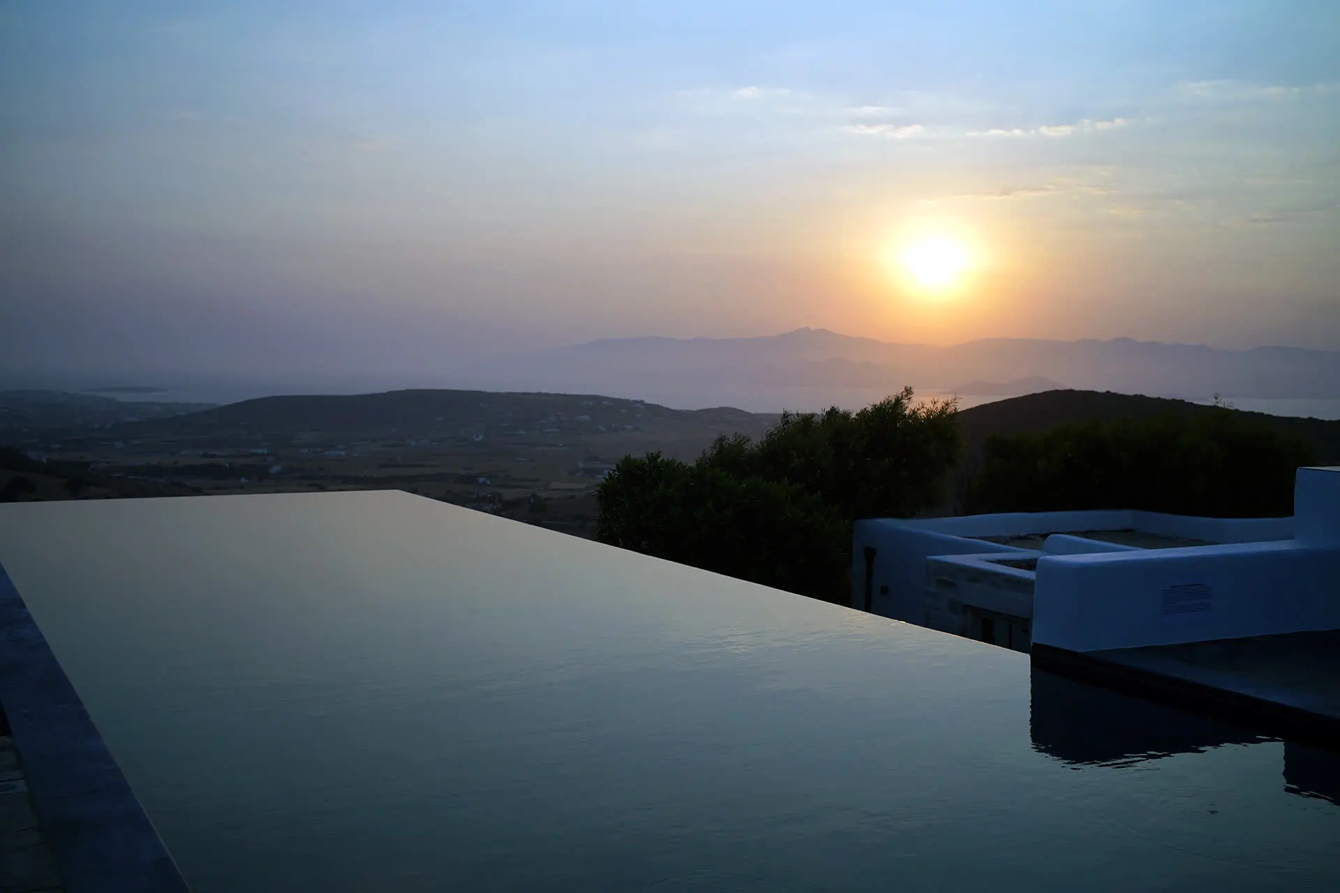 Villa Orian's 20-metre infinity pool at sunset, overlooking the Aegean